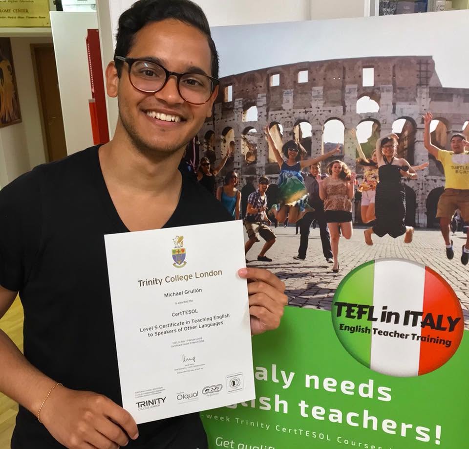 Graduate holding his Trinity CertTESOL certificate in Rome